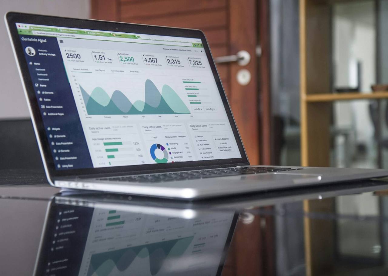 A laptop on a desk showing an operational reporting dashboard
